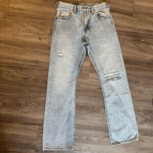 Levi's 517 Light Blue Bootcut Jeans with Distressed Knees
